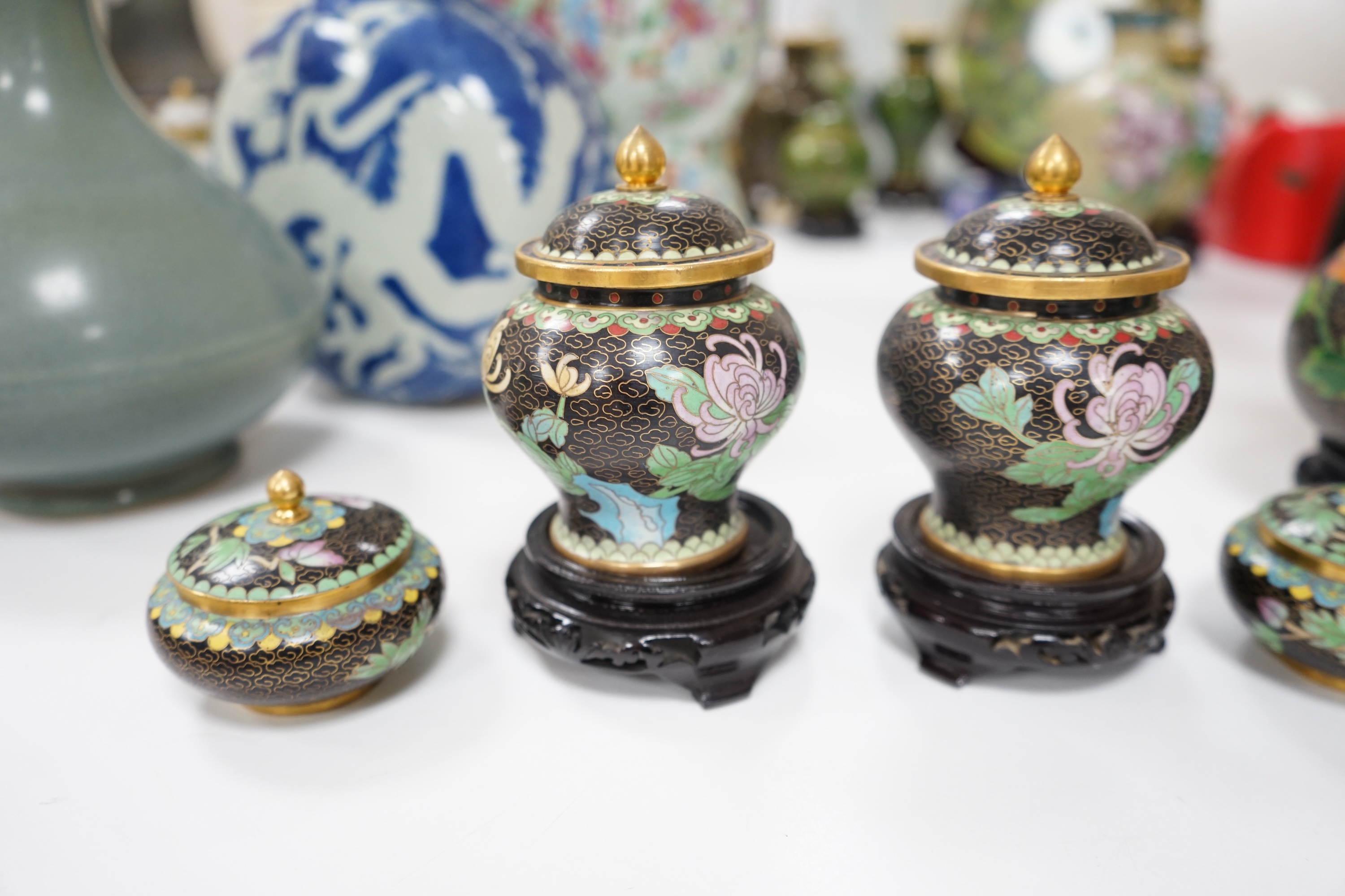 A collection of Chinese cloisonné enamel vessels, some with stands, all worked on a black background in floral designs, plate 26cm diameter. Condition - good